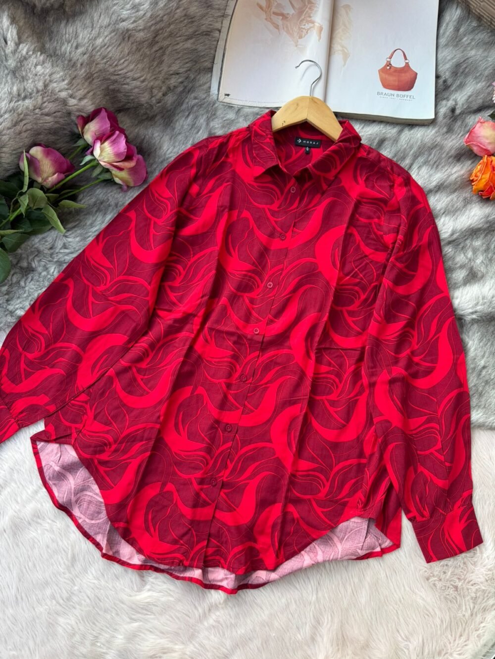 Red abstract swirl printed long sleeve shirt for women, vibrant button-down top.