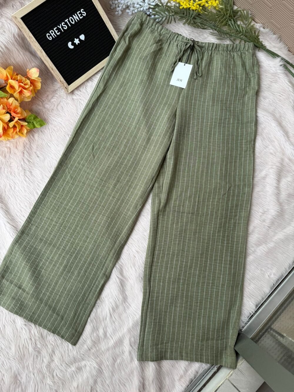 Single olive green cotton wide-leg pants with vertical white stripes and elastic waistband