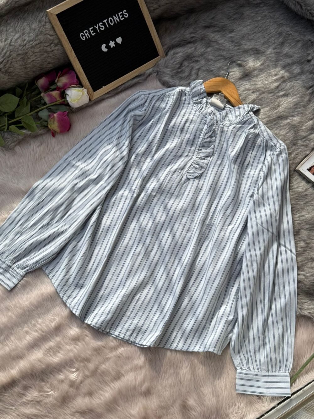 Women’s light blue and white striped blouse with ruffle neckline