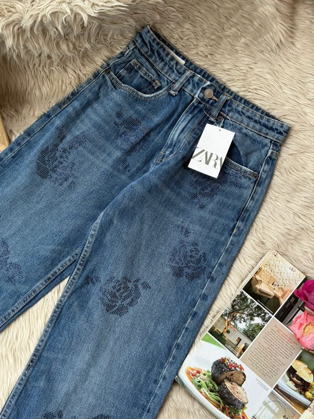 Dark blue denim jeans featuring subtle navy floral embroidery pattern