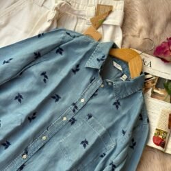 Light blue denim shirt with navy floral embroidery