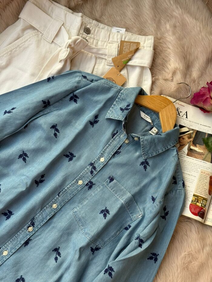 Light blue denim shirt with navy floral embroidery