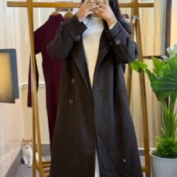 A long brown women’s wool-blend trench coat with double-breasted buttons