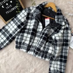 Black and white plaid cropped sherpa fleece jacket with zip-up front and elastic hem