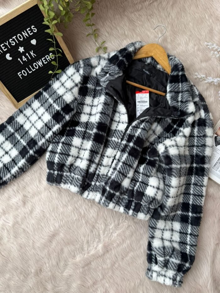 Black and white plaid cropped sherpa fleece jacket with zip-up front and elastic hem