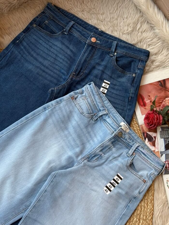 Two pairs of women’s baggy denim jeans in light and dark blue