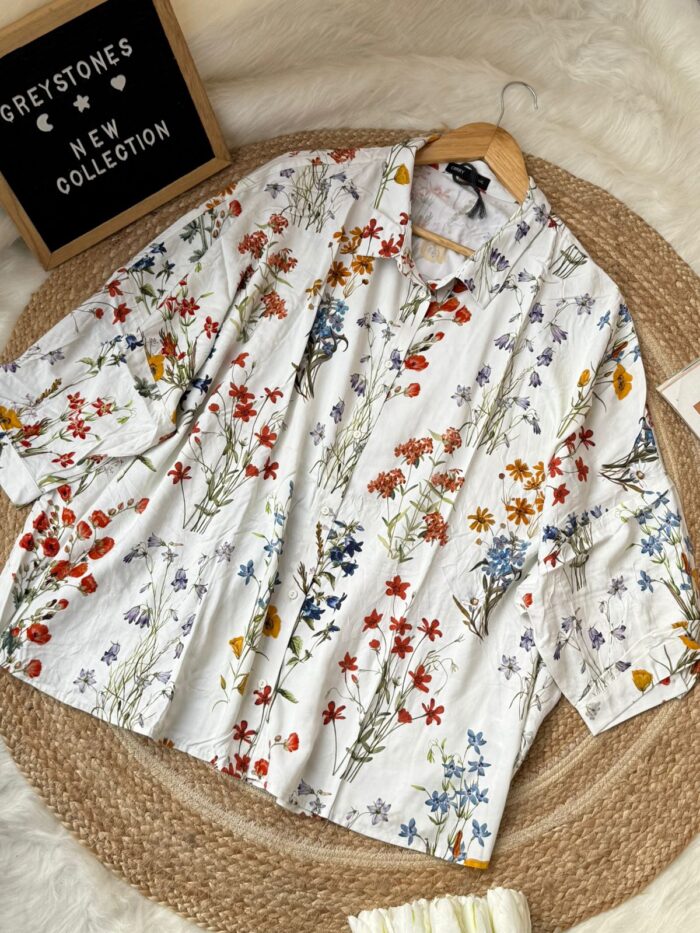 White short sleeve women’s shirt with colorful floral print and button-down design