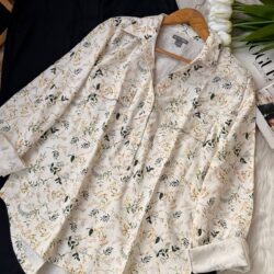 Vintage floral print women’s button-up shirt flat lay