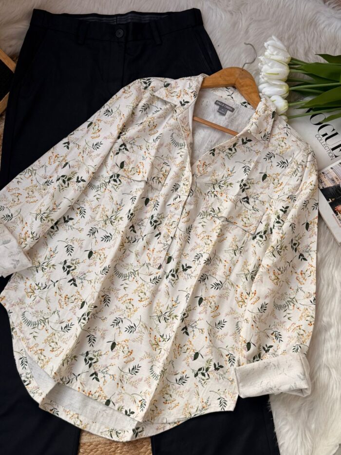 Vintage floral print women’s button-up shirt flat lay